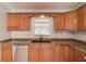 Modern kitchen with stylish wood cabinets, granite counters, and stainless dishwasher at 3625 Knoll Crest Trl, Buford, GA 30519