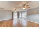 Living room featuring hardwood floors, ceiling fans, and a sliding door to the backyard at 3625 Knoll Crest Trl, Buford, GA 30519