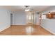 Open-concept living room with hardwood floors, leading to the front door and kitchen at 3625 Knoll Crest Trl, Buford, GA 30519