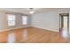 Bright living room featuring gleaming hardwood floors and natural light at 3625 Knoll Crest Trl, Buford, GA 30519