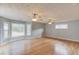 Spacious living room featuring hardwood floors, fan and many windows for natural light at 3625 Knoll Crest Trl, Buford, GA 30519