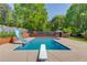 Beautiful backyard pool area featuring a diving board and slide perfect for summertime fun at 3625 Knoll Crest Trl, Buford, GA 30519
