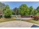 Backyard oasis with a sparkling swimming pool, mature trees, slide and a cozy firepit area at 3625 Knoll Crest Trl, Buford, GA 30519
