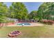 Relaxing pool and firepit combination, creating an ideal backyard for entertaining and leisure at 3625 Knoll Crest Trl, Buford, GA 30519