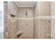 Nicely tiled shower featuring a handheld shower fixture, convenient hooks and a corner seat at 3625 Knoll Crest Trl, Buford, GA 30519