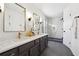 Bathroom with double sink vanity, stylish mirror and elegant glass enclosed shower at 704 Carriage Ct, Lawrenceville, GA 30044