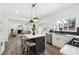 Open-concept kitchen with an island, pendant lighting, stainless steel appliances, and modern finishes at 704 Carriage Ct, Lawrenceville, GA 30044