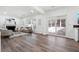 Spacious living room filled with natural light featuring a fireplace, neutral palette, and access to sunroom at 704 Carriage Ct, Lawrenceville, GA 30044