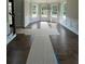 Sun-drenched dining room with classic wainscoting, hardwood floors, and large bay windows at 8013 White Stone Blvd, Douglasville, GA 30135