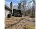 Backyard view featuring screened-in porch with wood deck, grass, and wooded lot at 9033 Greystone Rd, Jonesboro, GA 30238