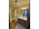 Bathroom with shower/tub combination, toilet, vanity with ample storage, and large mirror at 9033 Greystone Rd, Jonesboro, GA 30238