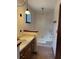 Cozy bathroom with a single sink vanity, dark wood trim, patterned wallpaper and combination tub and shower at 9033 Greystone Rd, Jonesboro, GA 30238