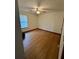 Simple bedroom with light hardwood floors, window, and ceiling fan, ready for your personal touch at 9033 Greystone Rd, Jonesboro, GA 30238