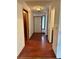 Hallway with wood floors leads to front door; features side window and closet at 9033 Greystone Rd, Jonesboro, GA 30238