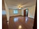 Spacious main bedroom with wood floors and ceiling fan; has ensuite bath and walk in closet at 9033 Greystone Rd, Jonesboro, GA 30238