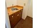 Small sink and cabinet area with wood countertop, located near kitchen at 9033 Greystone Rd, Jonesboro, GA 30238