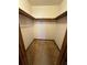Walk-in closet with carpet, shelves and a wooden rod for hanging clothes at 9033 Greystone Rd, Jonesboro, GA 30238