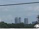 Distant skyline view featuring office towers, captured on a partly cloudy day at 2134 Nw Abner Nw Pl, Atlanta, GA 30318
