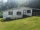 Exterior view of a house with a green lawn, trees, and a covered entry at 2134 Nw Abner Nw Pl, Atlanta, GA 30318