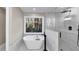 Modern bathroom featuring a soaking tub, glass-enclosed shower, and natural views at 3017 Lana Ln, Marietta, GA 30066