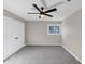 Bright bedroom with gray carpet, a ceiling fan, a window, light gray paint, and a closet at 3017 Lana Ln, Marietta, GA 30066