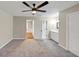 Neutral-toned bedroom boasting ceiling fan, carpeted floor, and ensuite with a bright, tiled vanity at 3017 Lana Ln, Marietta, GA 30066
