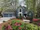 Charming blue two-story home with landscaped yard, two car garage, and blooming azaleas at 3017 Lana Ln, Marietta, GA 30066