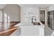 Modern white kitchen boasts sleek quartz countertops, stainless steel appliances, and hardwood floors at 3017 Lana Ln, Marietta, GA 30066