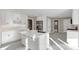 Bright, all-white kitchen featuring a central island with sink, stainless steel appliances, and tile floors at 3017 Lana Ln, Marietta, GA 30066