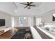 Digitally staged main bedroom featuring modern furniture and decor, tray ceilings, and hardwood floors at 3017 Lana Ln, Marietta, GA 30066