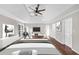 Digitally staged main bedroom featuring tray ceiling, hardwood floors and modern furniture at 3017 Lana Ln, Marietta, GA 30066