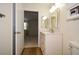 Bathroom with a single sink vanity featuring a marble countertop and an open doorway to an adjacent room at 475 Mount Vernon Ne Hwy # A-102, Sandy Springs, GA 30328