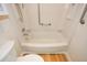 Bright bathroom featuring a tub and shower combination with safety handrails and modern fixtures at 475 Mount Vernon Ne Hwy # A-102, Sandy Springs, GA 30328