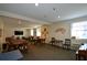 Versatile game room furnished with tables, chairs, TV, and card-themed decor, perfect for community engagement at 475 Mount Vernon Ne Hwy # A-102, Sandy Springs, GA 30328