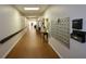 Well-lit hallway with wood floors, handrails, and mailboxes for convenient resident access at 475 Mount Vernon Ne Hwy # A-102, Sandy Springs, GA 30328