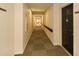 Long hallway with doors on the right with beige walls and carpeted floor at 475 Mount Vernon Ne Hwy # A-102, Sandy Springs, GA 30328