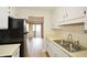 The kitchen features a stainless steel sink, plenty of counter space, and a view to the outdoor patio at 475 Mount Vernon Ne Hwy # A-102, Sandy Springs, GA 30328