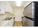 Efficient kitchen featuring white cabinets and stainless steel appliances at 475 Mount Vernon Ne Hwy # A-102, Sandy Springs, GA 30328