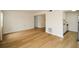 Neutral living area with hardwood flooring leading to the kitchen at 475 Mount Vernon Ne Hwy # A-102, Sandy Springs, GA 30328