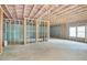 Unfinished basement with concrete floor, framed walls, pink insulation, and windows, presenting a blank canvas for customization at 603 Old Peachtree Ne Rd, Lawrenceville, GA 30043