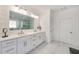 Bathroom featuring marble floors, double vanity, large mirror, and glass shower at 603 Old Peachtree Ne Rd, Lawrenceville, GA 30043