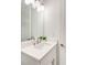 Bright bathroom with a large mirror, quartz countertop, and shaker cabinets at 603 Old Peachtree Ne Rd, Lawrenceville, GA 30043