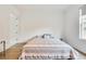 Bedroom with hardwood floors, neutral striped bedding, and a window with backyard views at 603 Old Peachtree Ne Rd, Lawrenceville, GA 30043