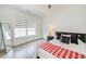 Well-lit bedroom featuring light hardwood floors, a full-length mirror, and a comfortable bed with stylish pillows at 603 Old Peachtree Ne Rd, Lawrenceville, GA 30043