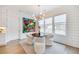 Bright breakfast nook with modern chandelier, white chairs, and a view of the fenced backyard at 603 Old Peachtree Ne Rd, Lawrenceville, GA 30043