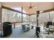 Covered deck with outdoor dining set, grill, ceiling fan, and views of the surrounding trees, creating a relaxing space at 603 Old Peachtree Ne Rd, Lawrenceville, GA 30043