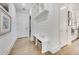 Hallway features a built-in bench and shelving unit with white walls and hardwood floors at 603 Old Peachtree Ne Rd, Lawrenceville, GA 30043