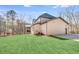 Rear view of home highlighting large yard and neutral brick exterior at 603 Old Peachtree Ne Rd, Lawrenceville, GA 30043
