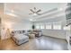 A cozy living room features a tray ceiling, modern fan, and a comfortable gray sectional sofa at 603 Old Peachtree Ne Rd, Lawrenceville, GA 30043