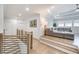 Spacious living room featuring wood floors, a large gray couch, multiple windows, recessed lights, and a tray ceiling at 603 Old Peachtree Ne Rd, Lawrenceville, GA 30043